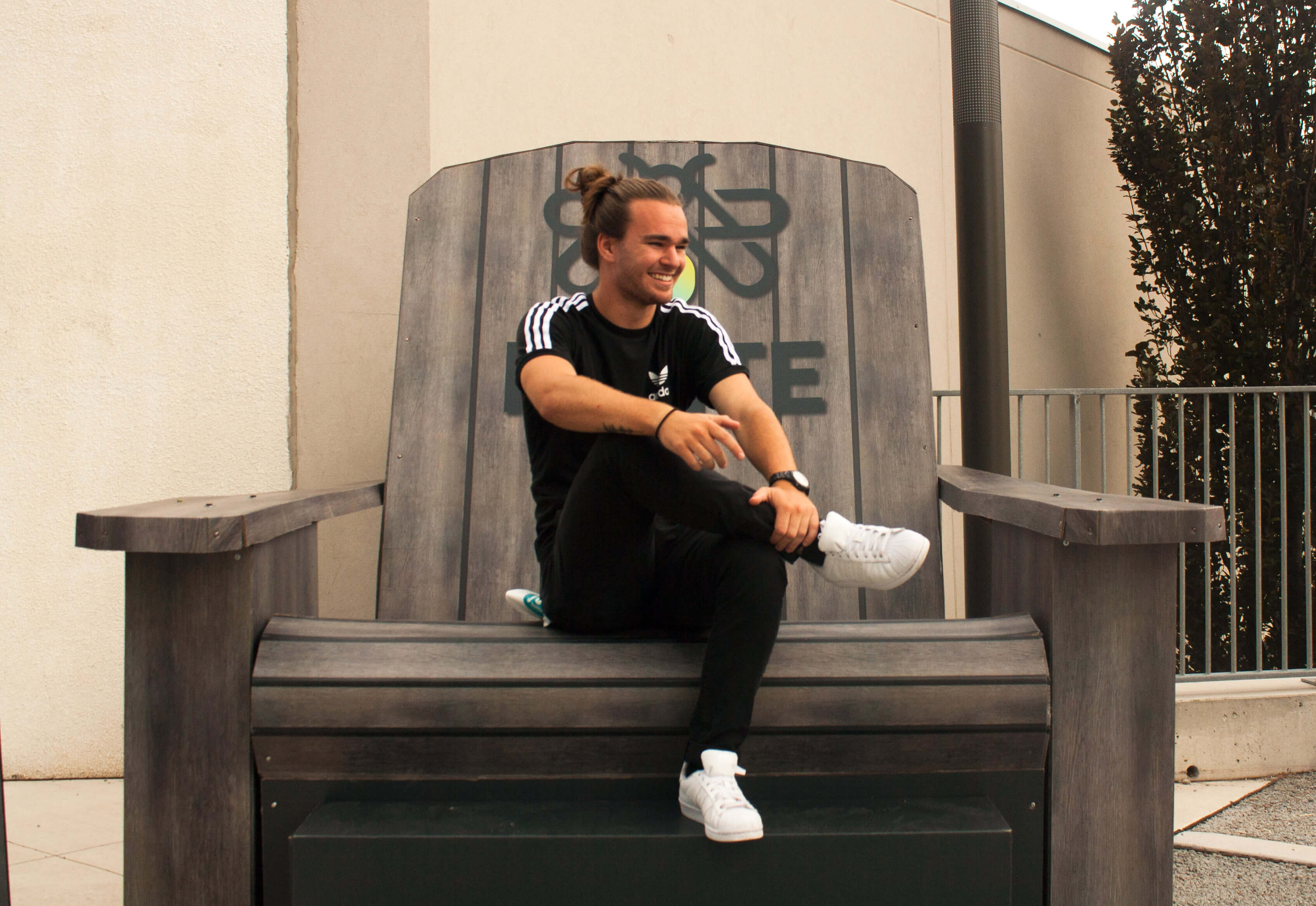 Joel wearing Black Adidas T-Shirt, Black Khakis and White Adidas Shoes