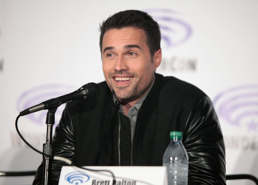 brett dalton at wondercon smiling while speaking on mic on panel