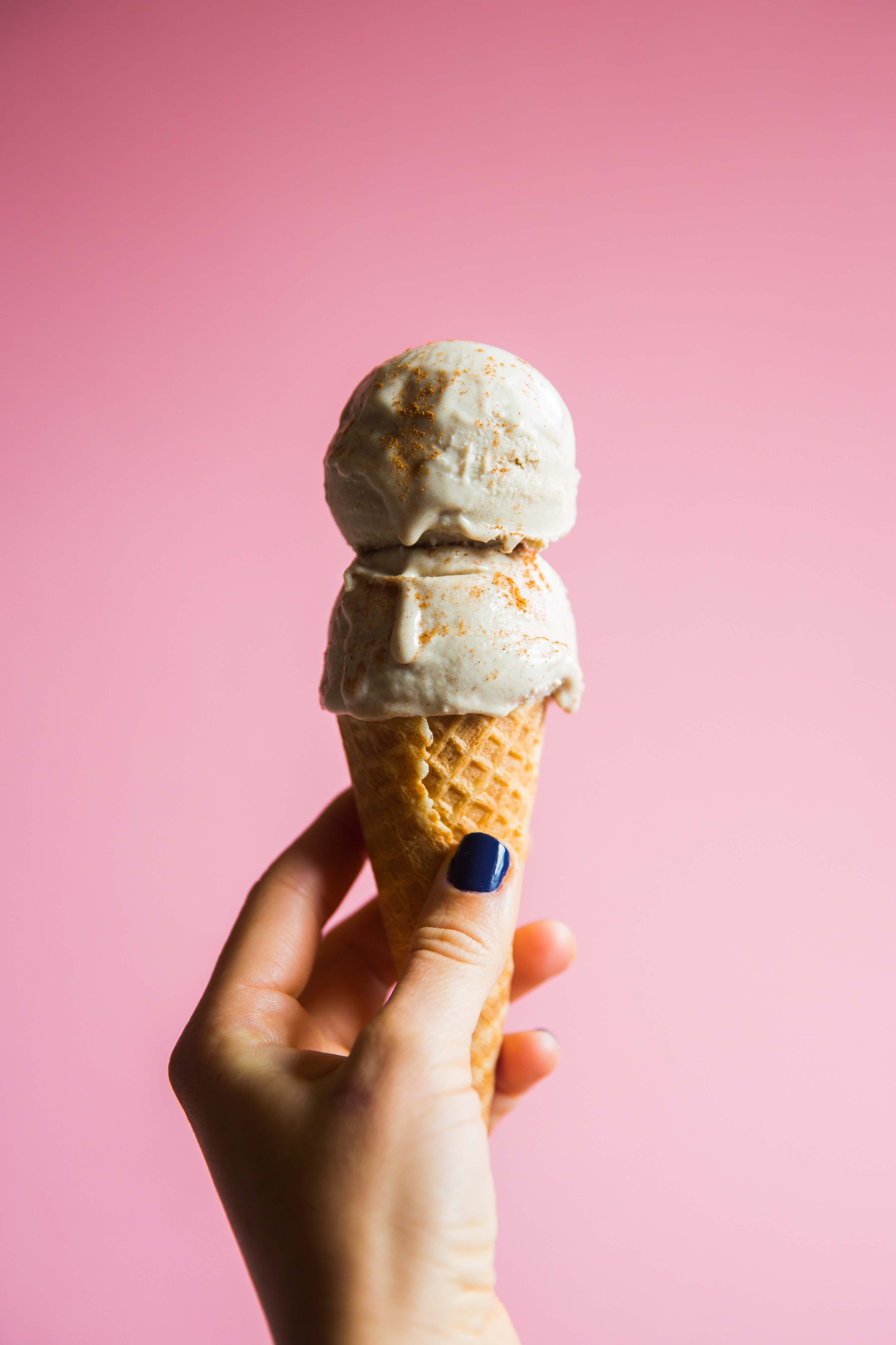 Girl holding ice cream cone with two scoops of ice-cream on top!