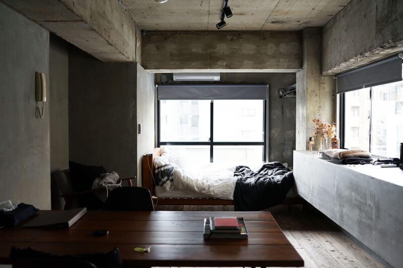 Clean bachelor bedroom with big window by the bed