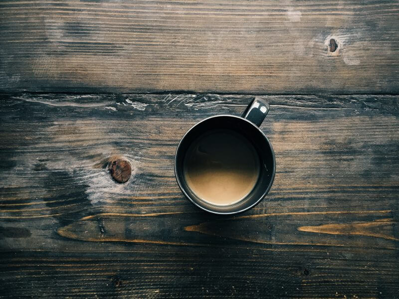 Coffee cup on wooden table.