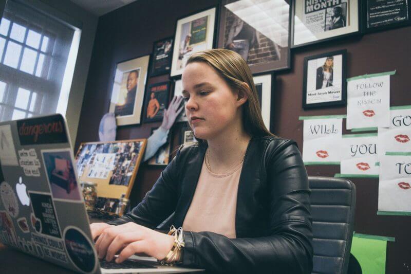 Melissa typing on laptop at Pressed office