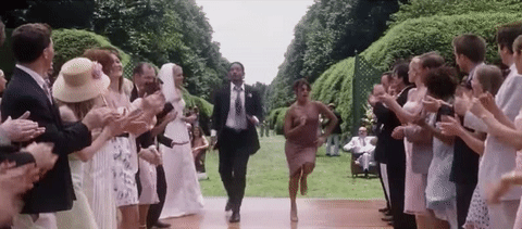 A couple dancing down the aisle of a wedding