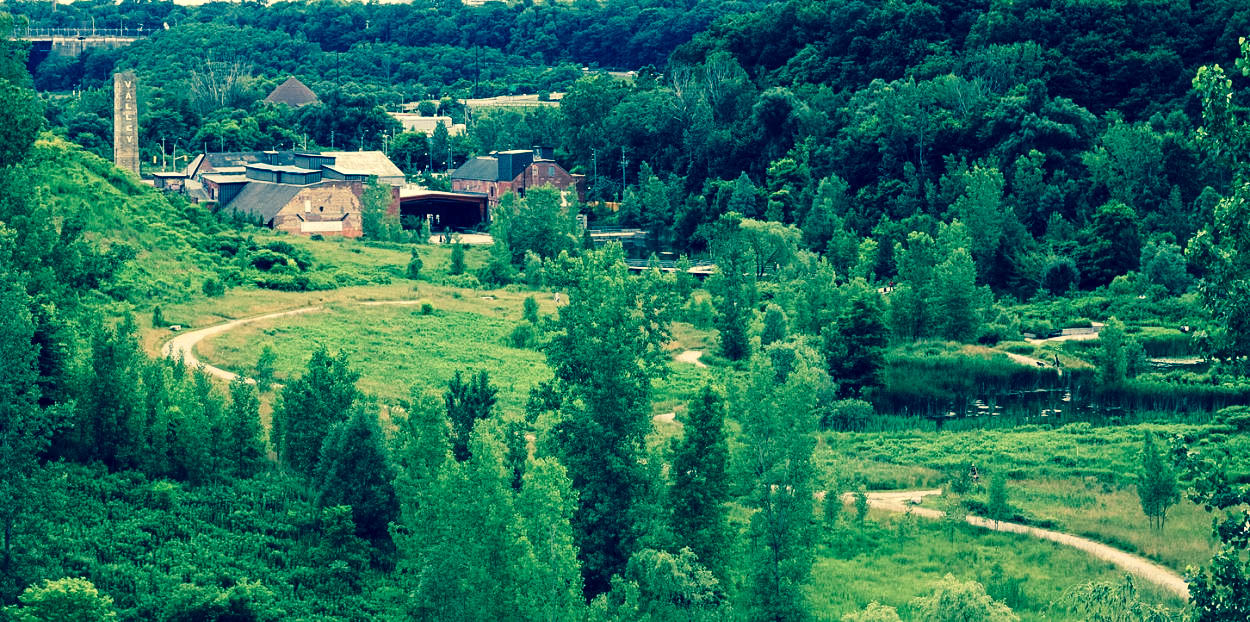 a large brick building nestled amidst lots of green forest