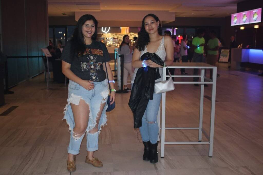 Two young female students wearing jeans and edgy tops
