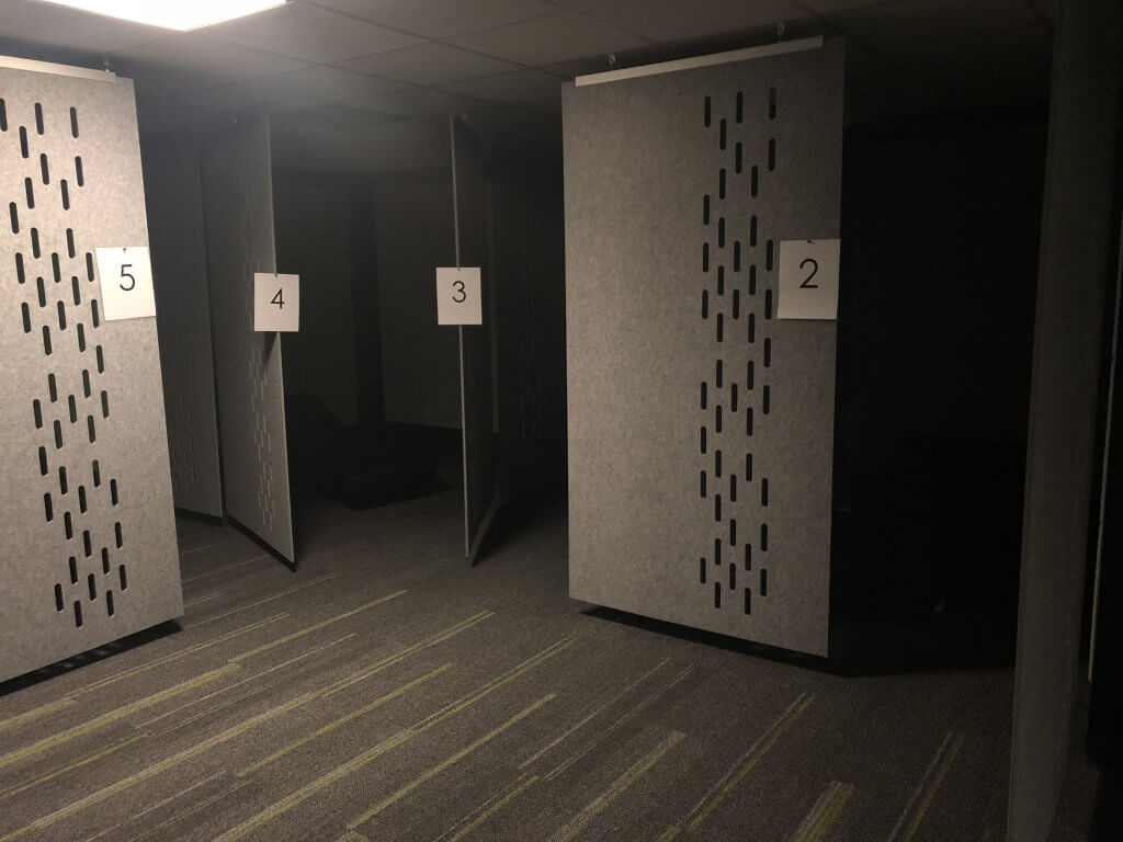 Several individually screened-in sleep pods in the IGNITE Sleep Lounge