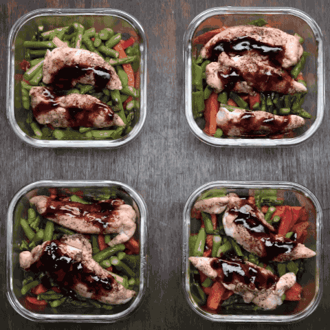 Person puts lids on four containers of food