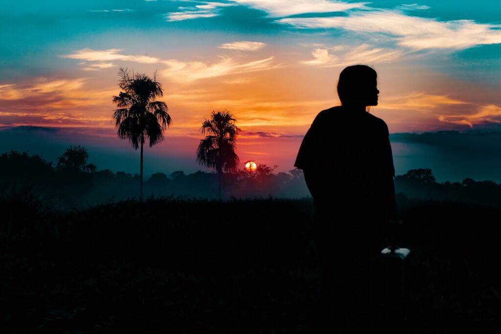 Girl looks out into the distance during sunset