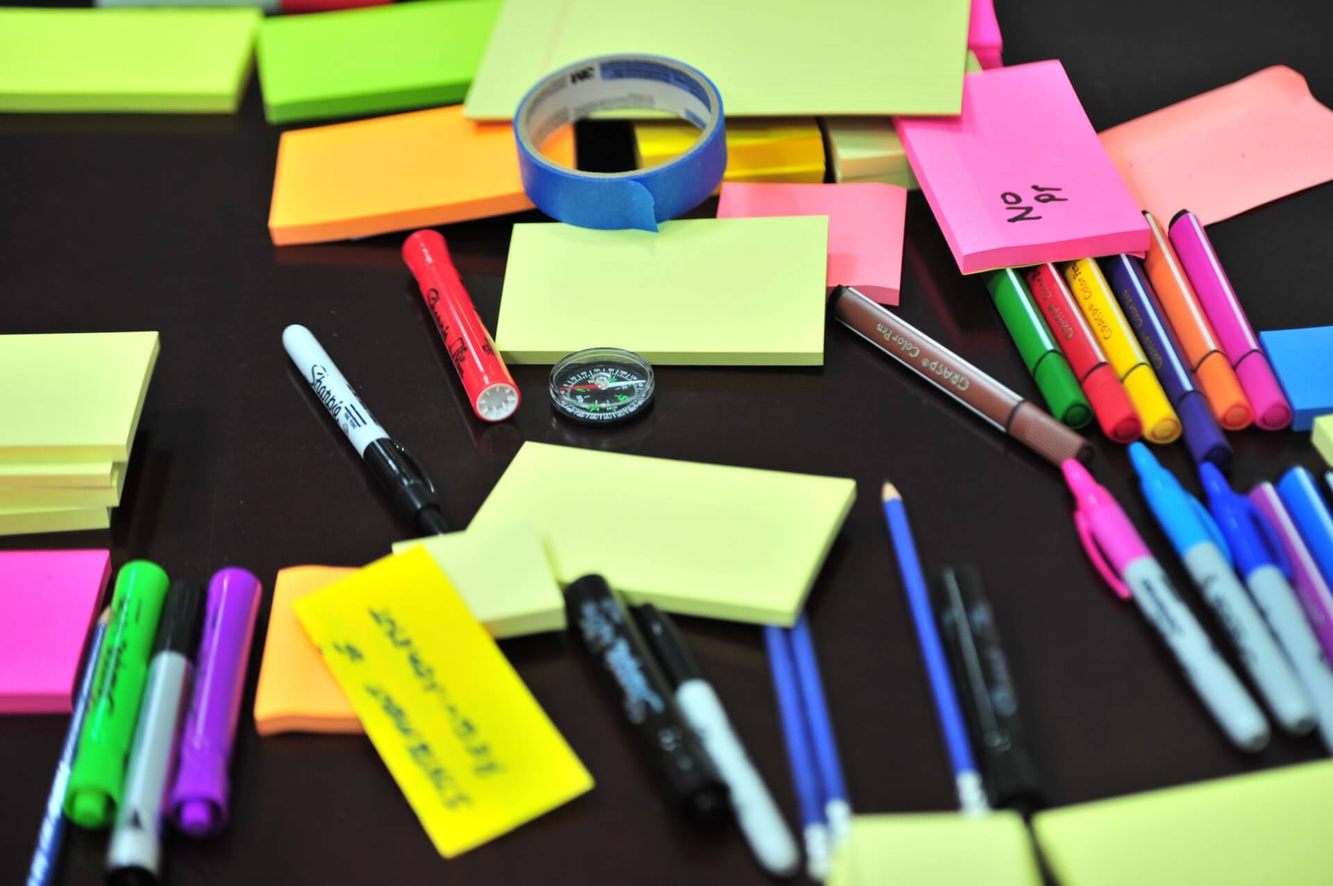 Table with coloured pens and sticky notes 