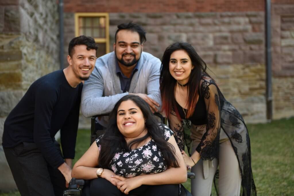 Four students smiling for the camera