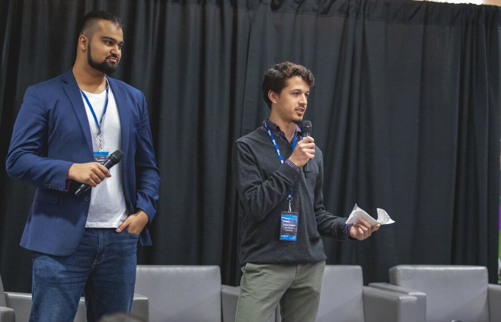 Two young men speaking to an audience
