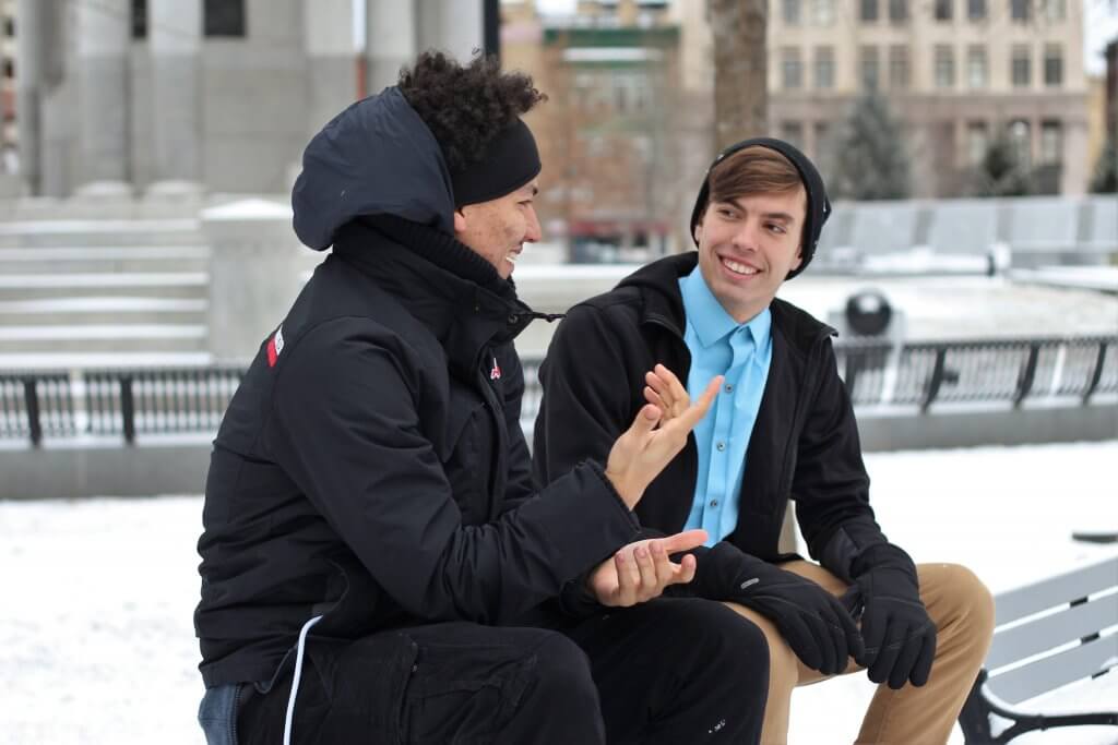 Two guys chatting outside