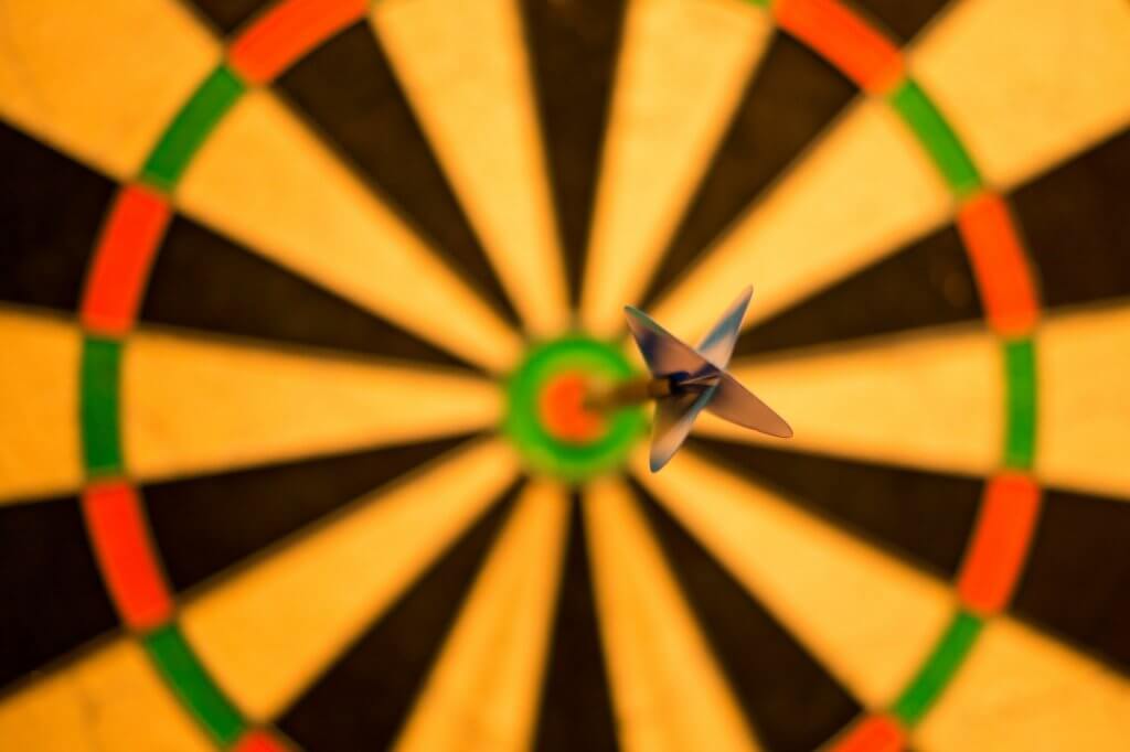 Close-up of a dart stuck on a bullseye on a dart board