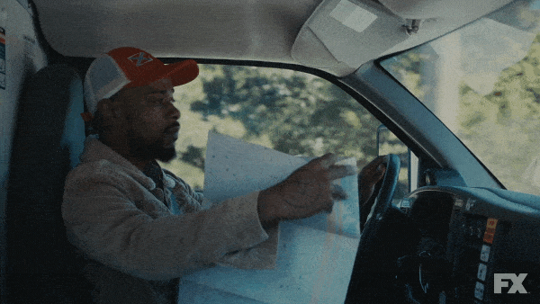 man looking at map while driving