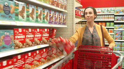 lady dropping an entire shelf of cookies into her cart.