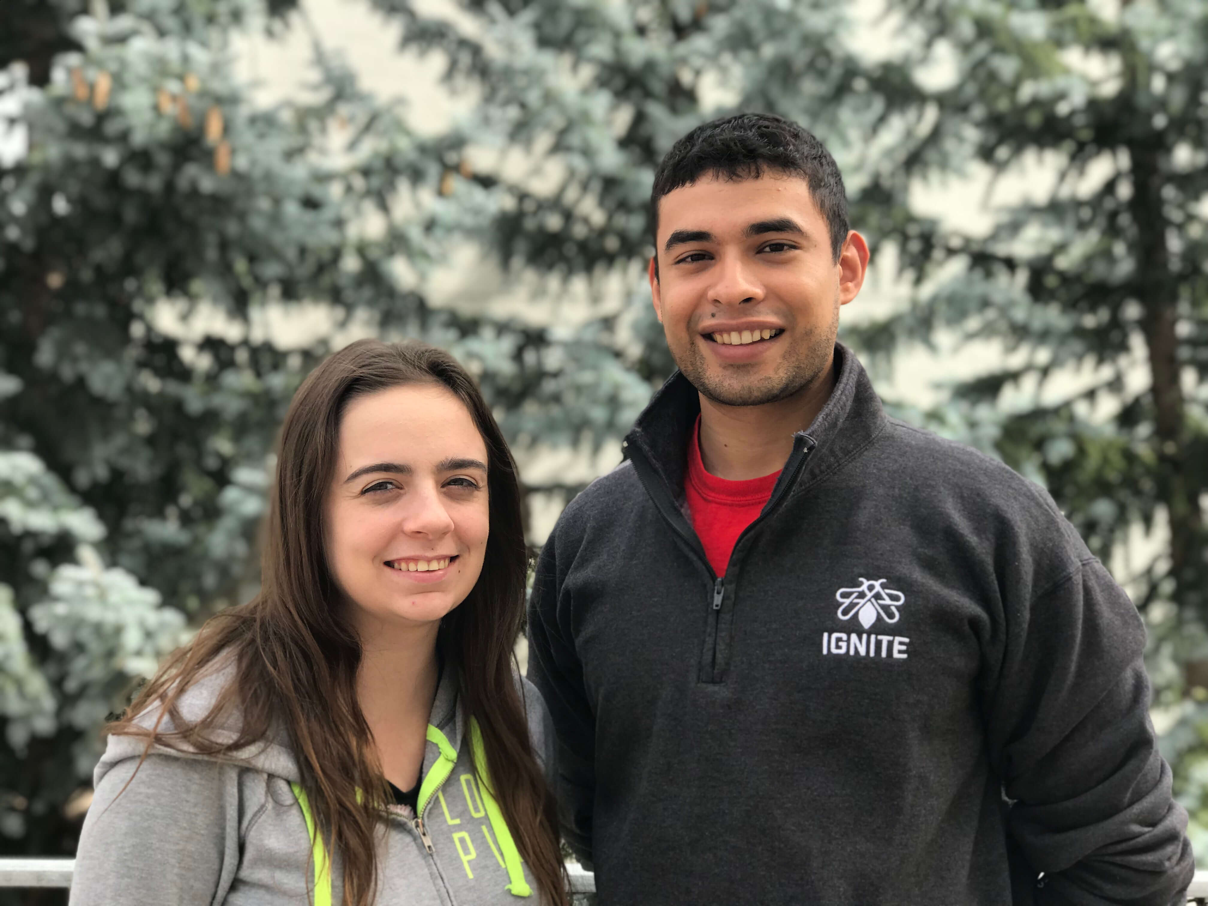 a girl and boy standing next to each other
