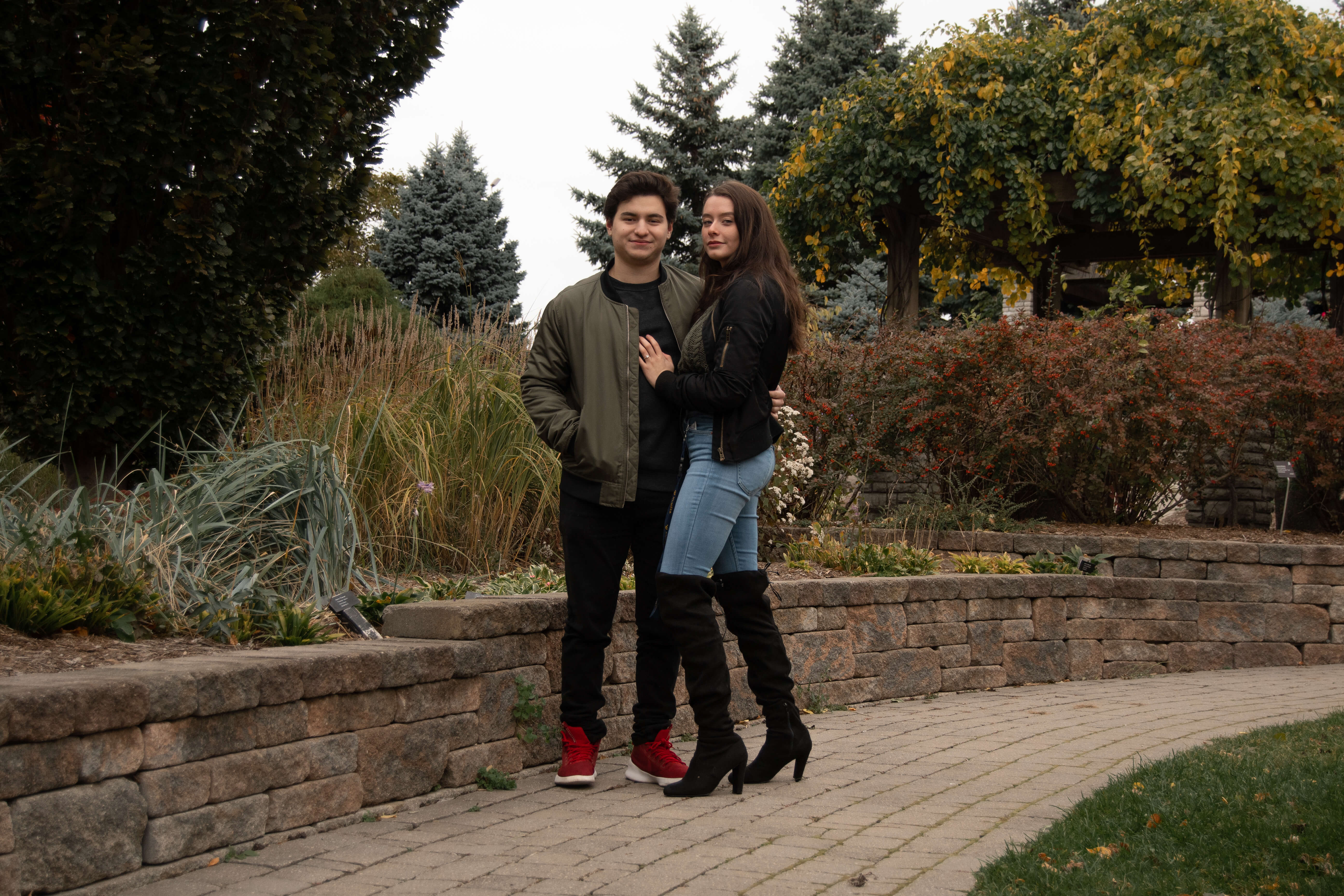2 students wearing coordinating fall colours pose in the Humber Arboretum