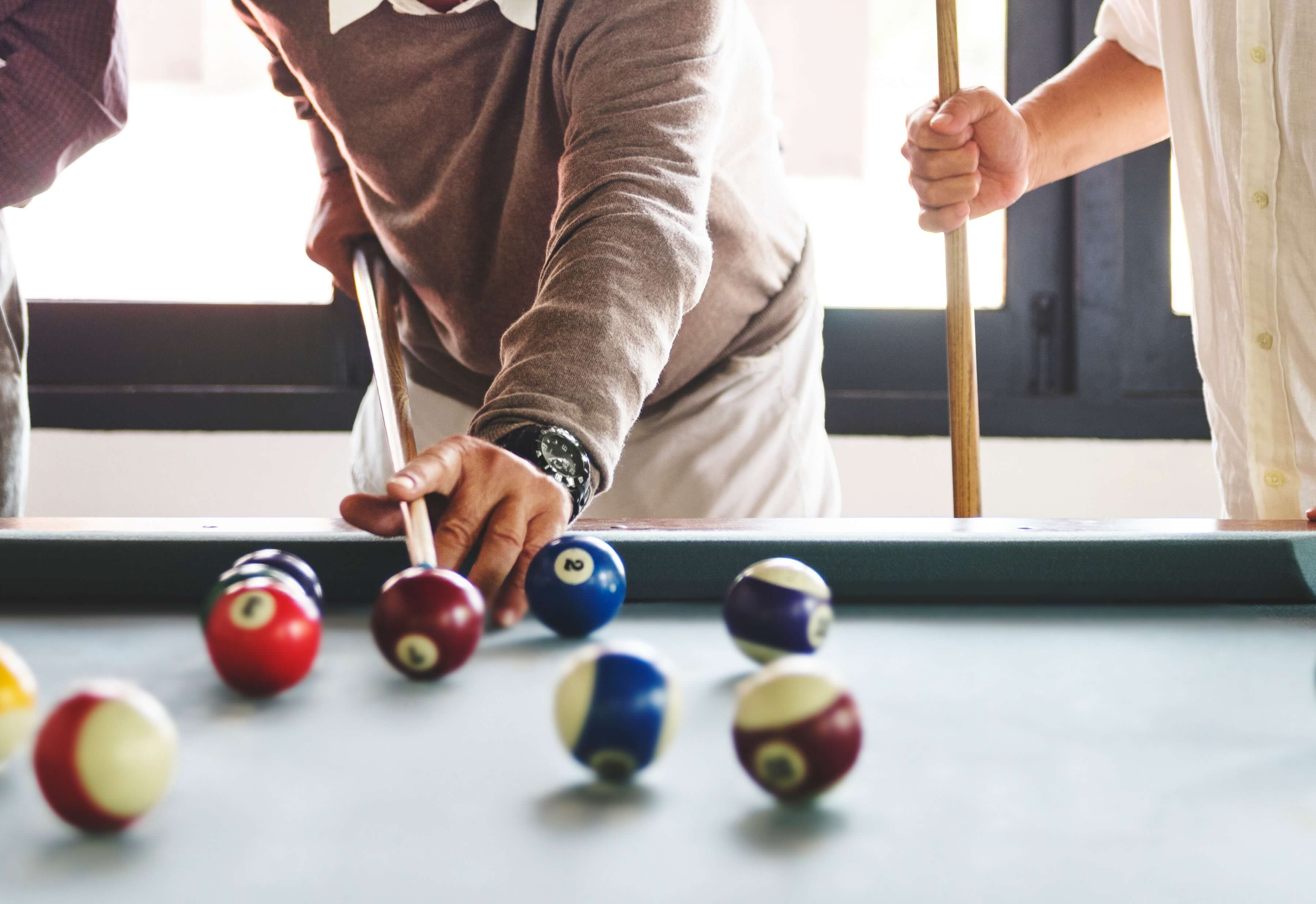 People playing a game of pool.