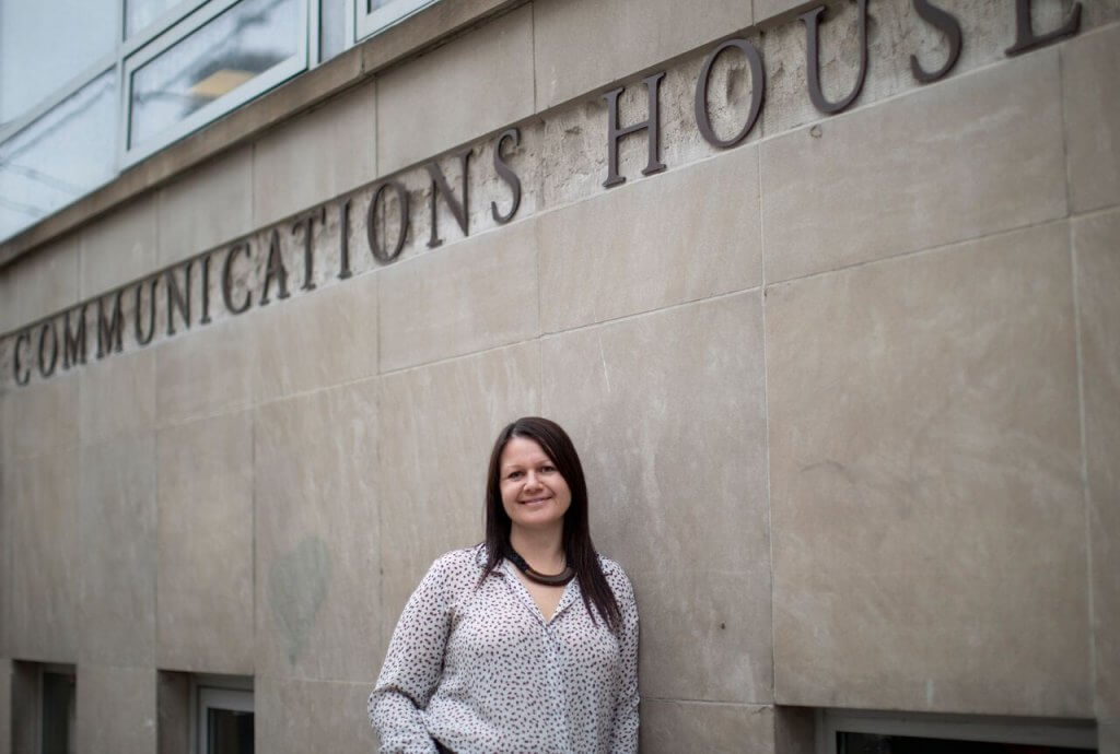 Larysa Woloszansky stand outside the University of Toronto Communications House.