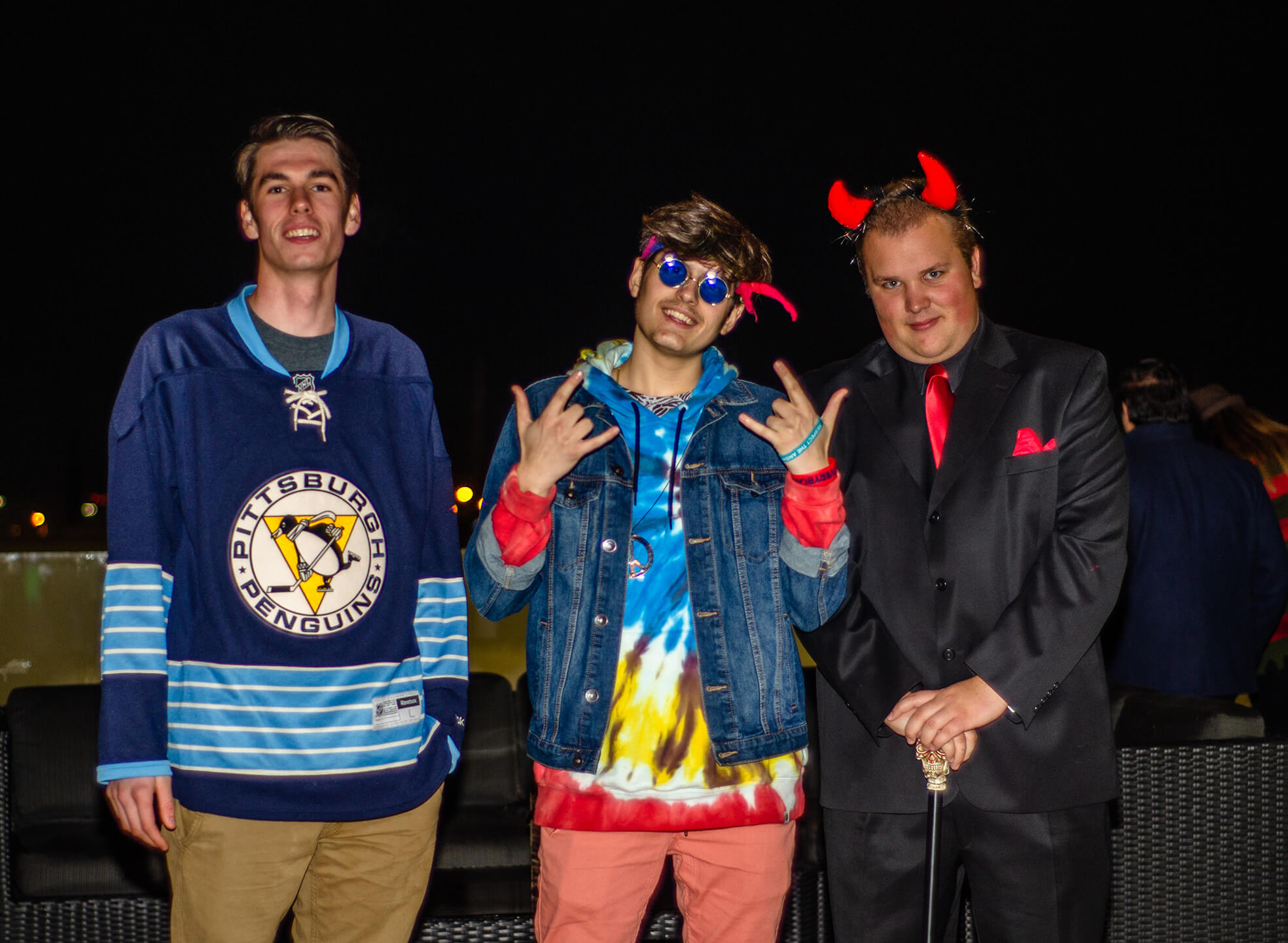 three guys in halloween costumes pose at IGNITE party