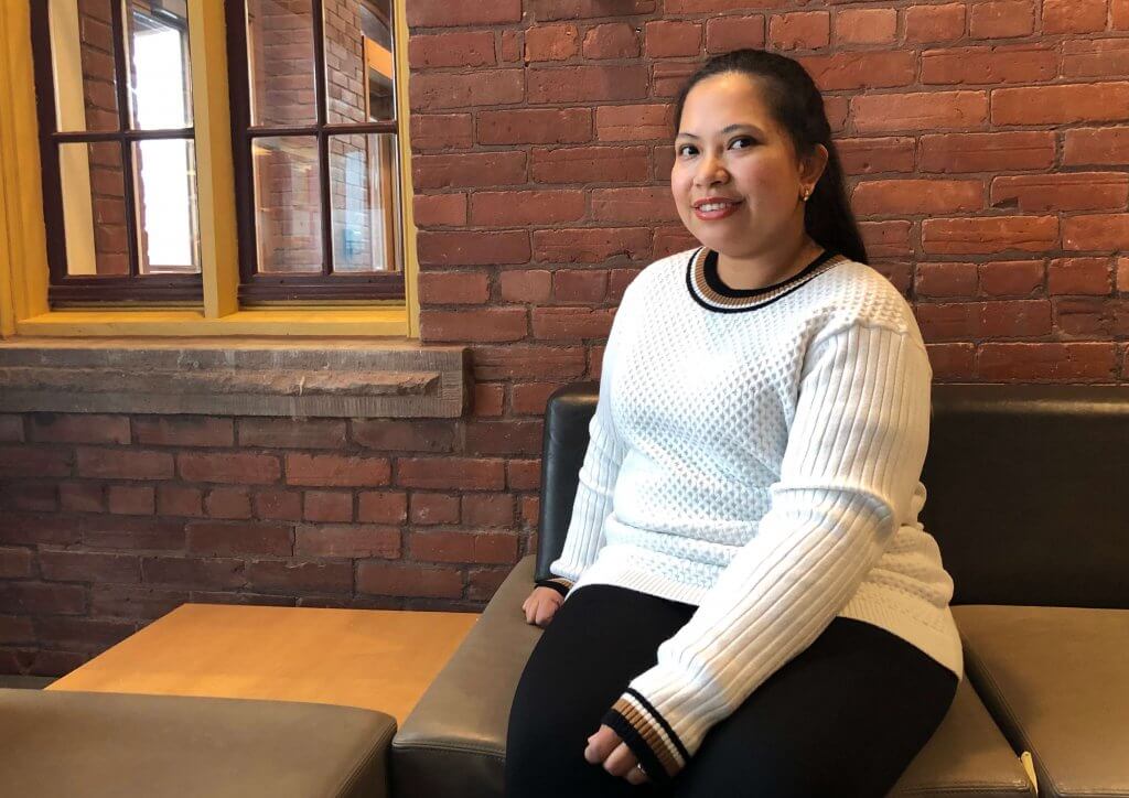 Emmalyn Giray sitting on a bench at Humber's International Centre.