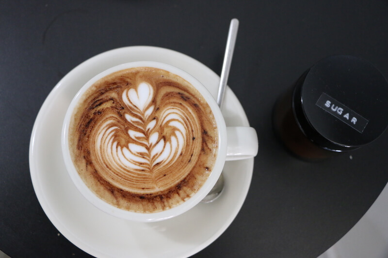 Cappuccino next to container reading "sugar"