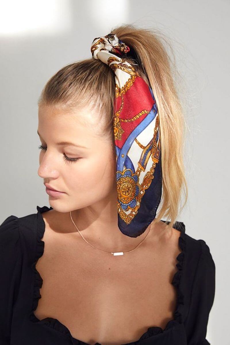 Woman with blonde hair wearing silk hair scarf