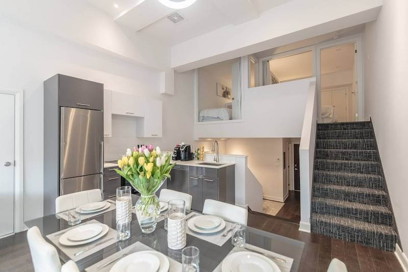 Interior of white loft kitchen and bedrooms