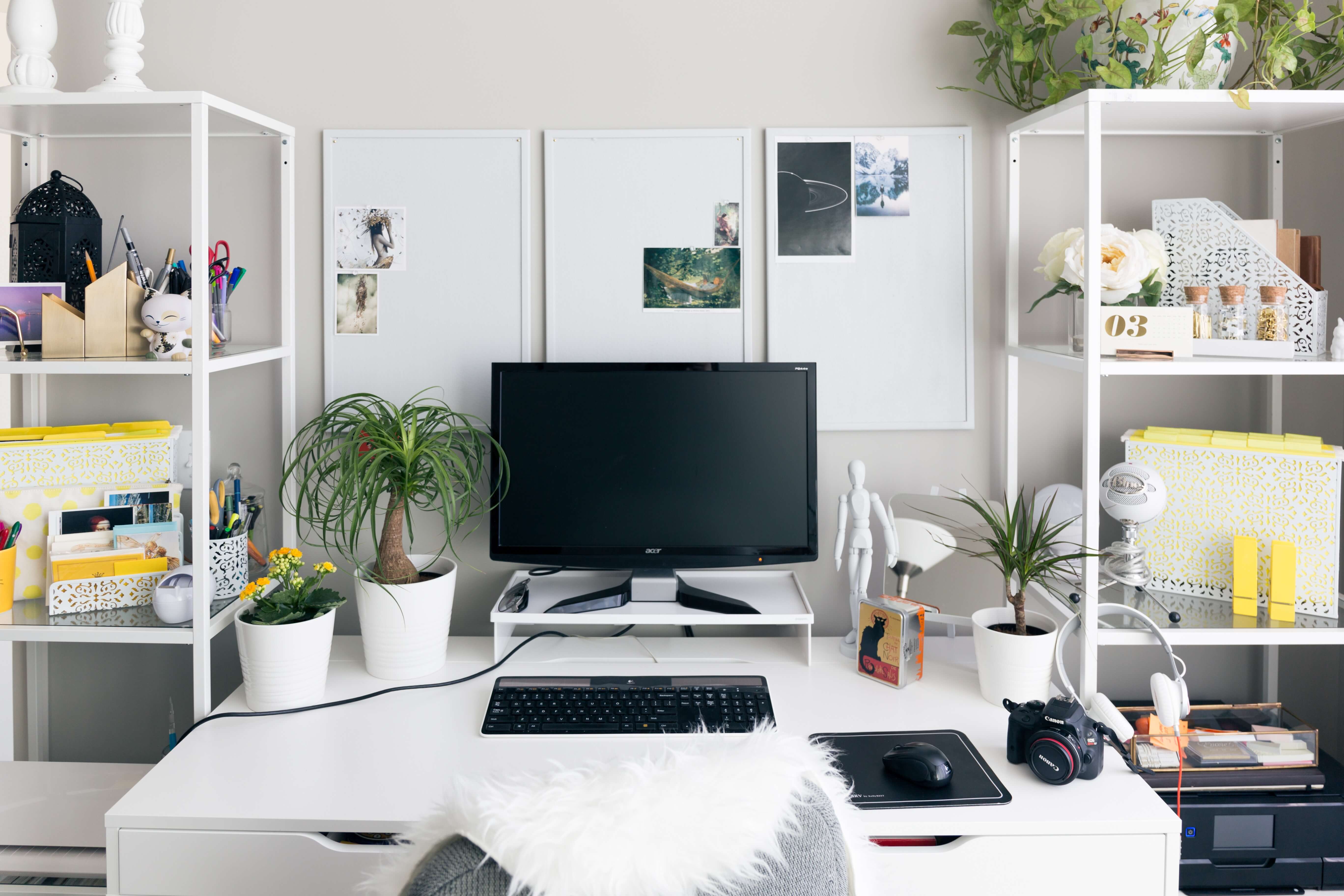 computer setup on white wooden table with desk supplies