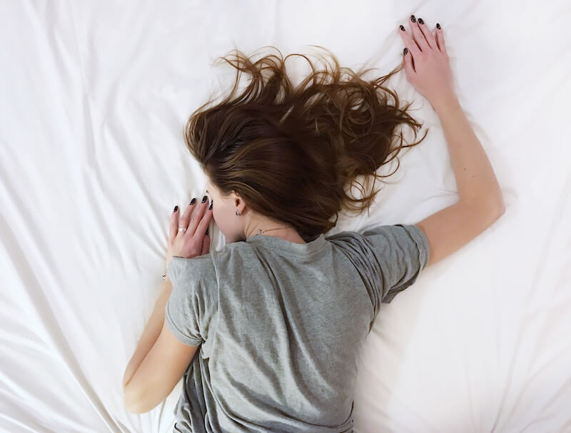 women asleep on back in bed