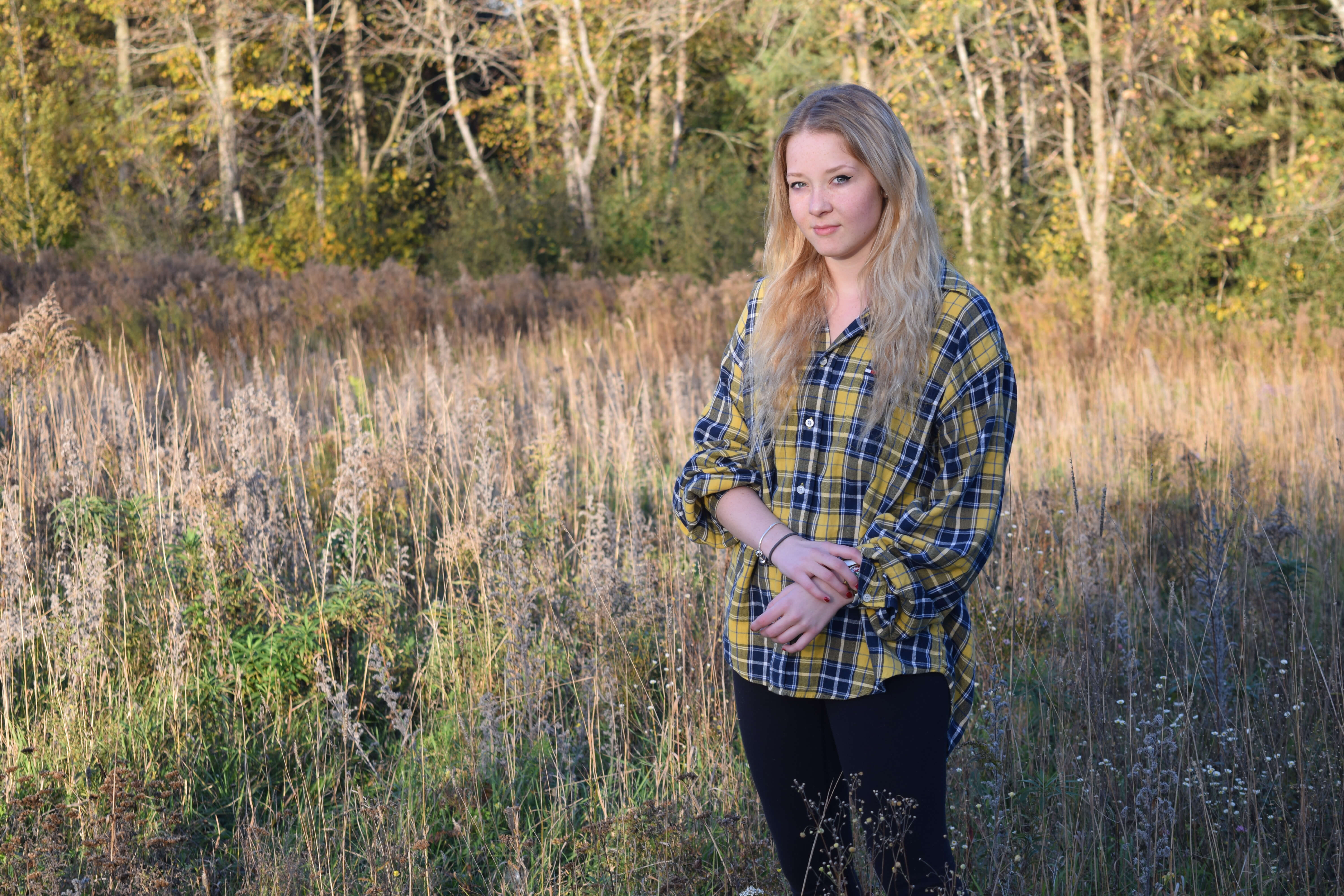 Girl standing in tall grass.