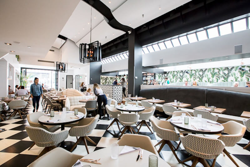 tables and chairs in Planta restaurant with checkered floors