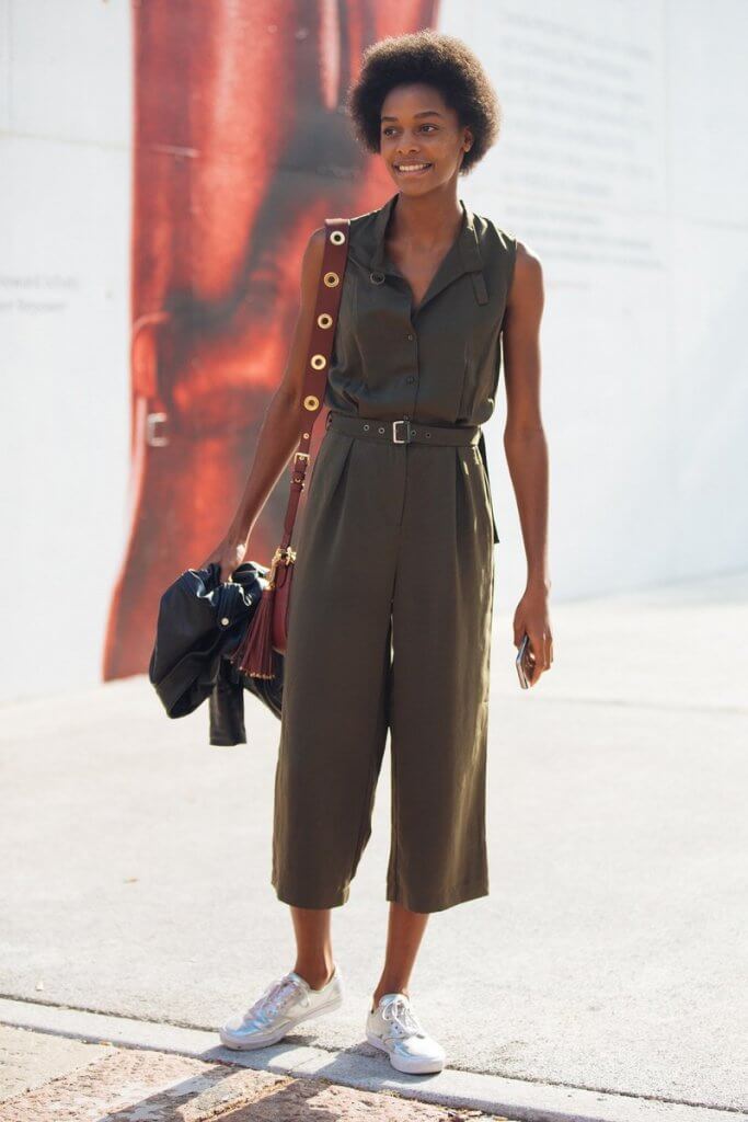 Woman on street wearing jumpsuit.