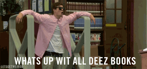Man wearing sunglasses in library.