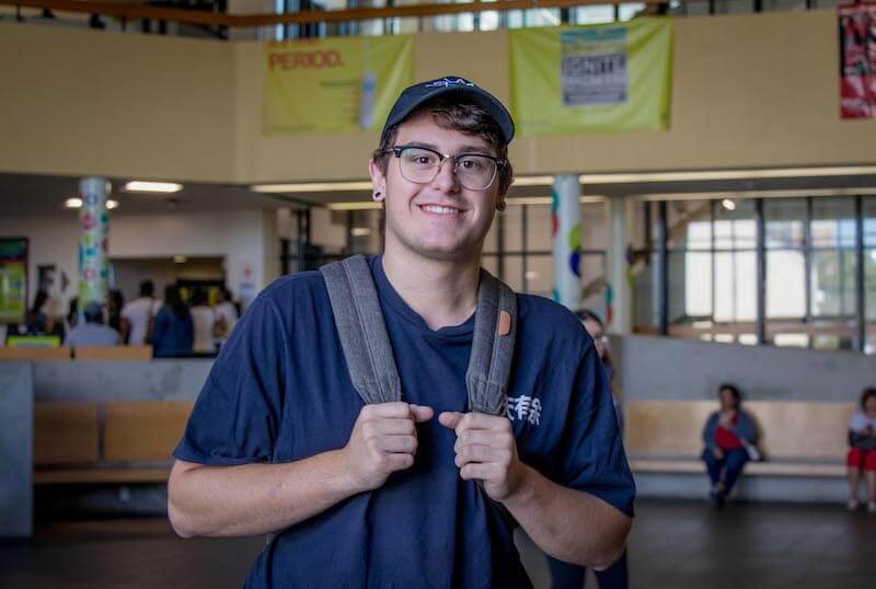boy wearing glasses, backpack and cap in humber college