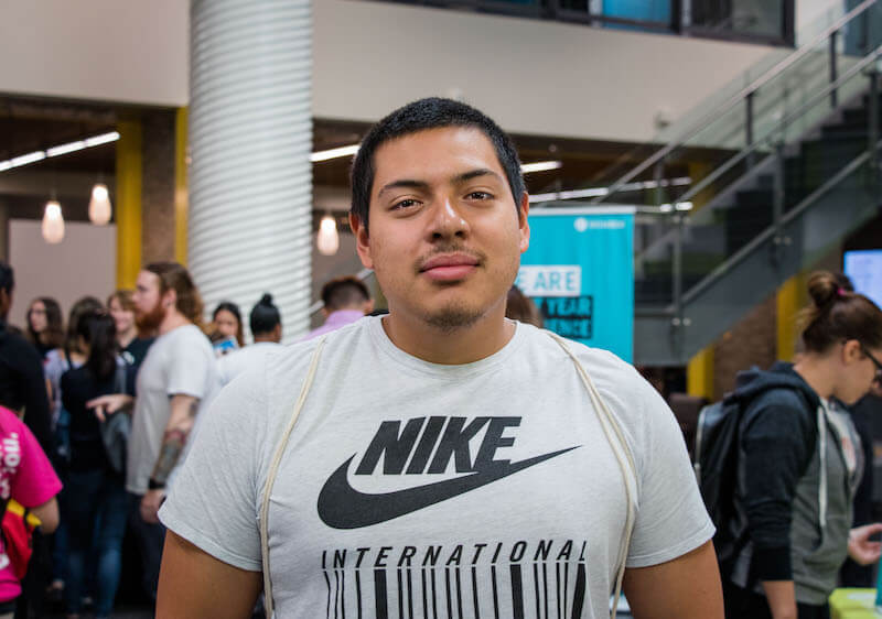 boy wearing white Nike International shirt