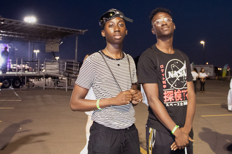 2 guys standing in parking lot