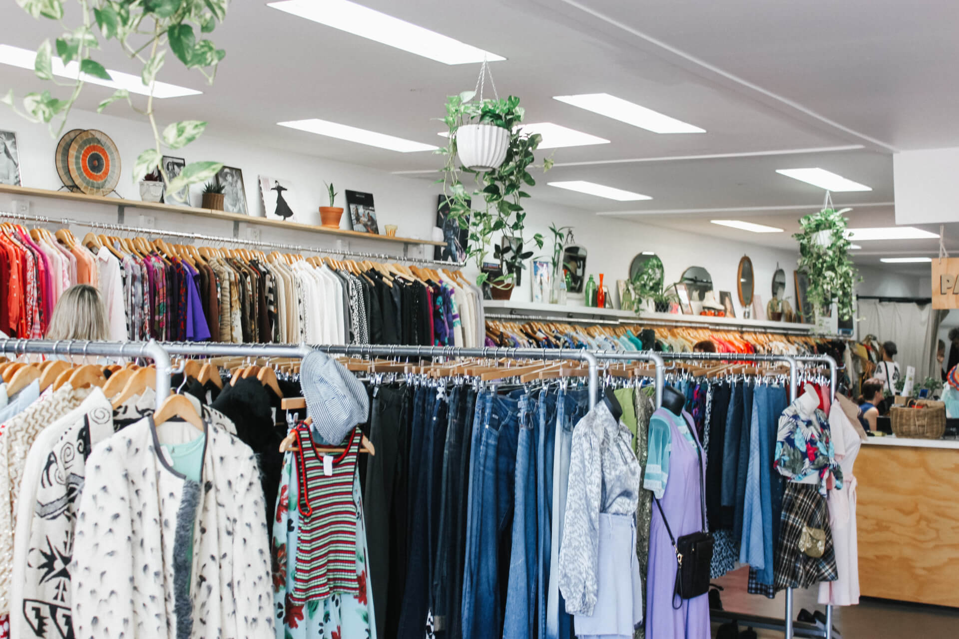 clothing hanging on racks in thrift store
