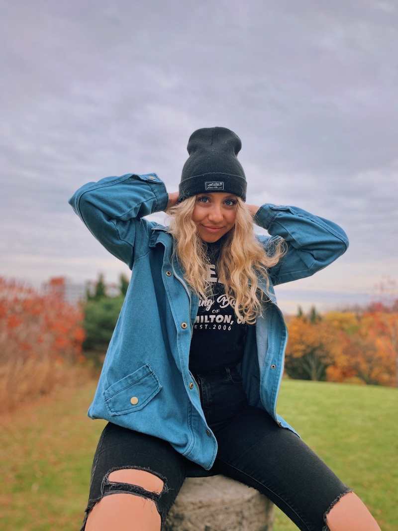girl sitting atop hill