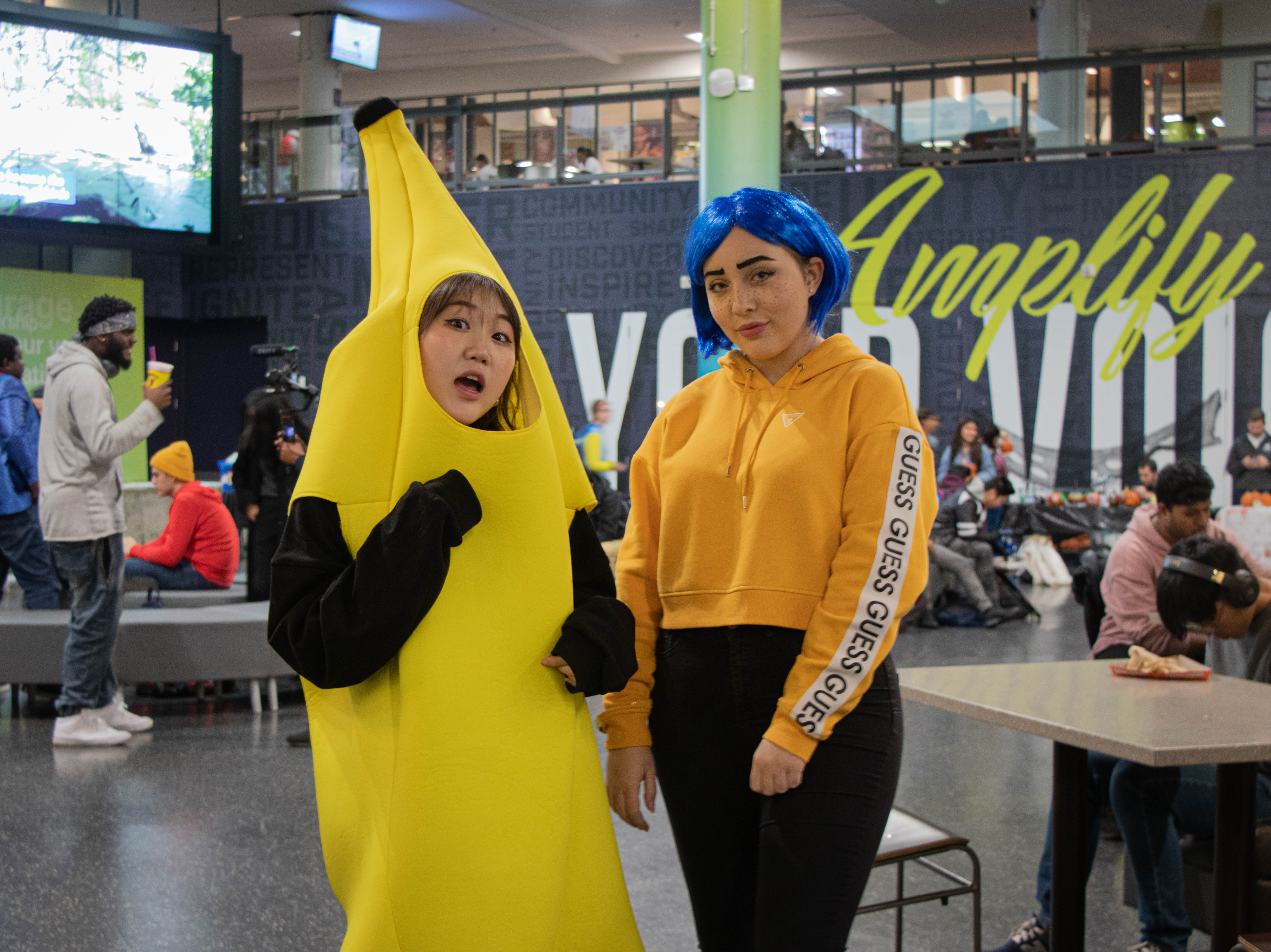 two girls pose in costume