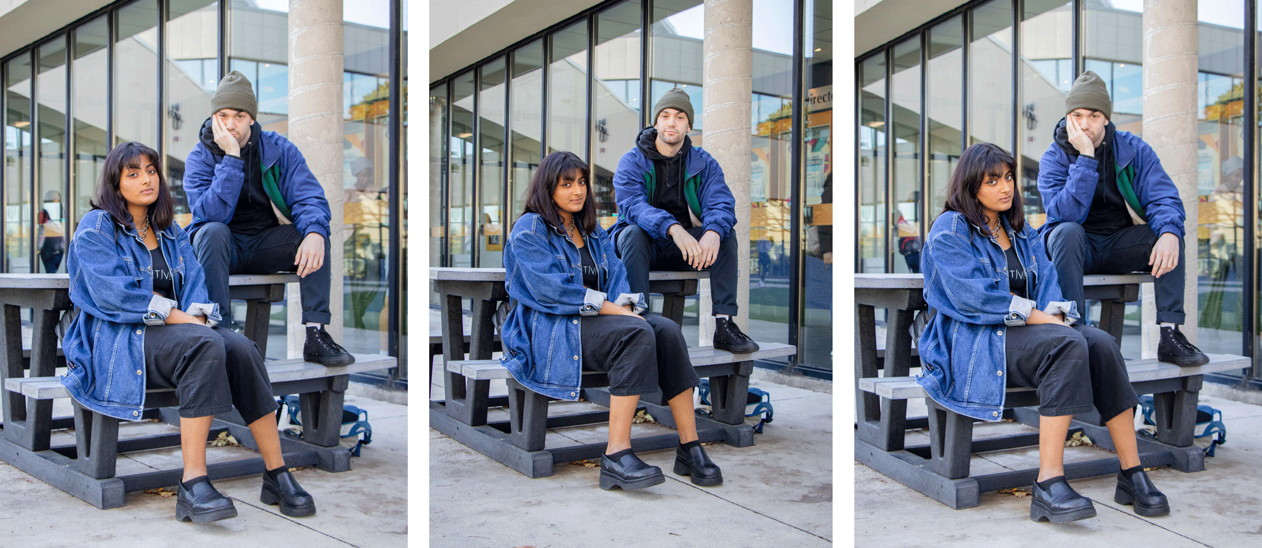 two students sit on a picnic table outside