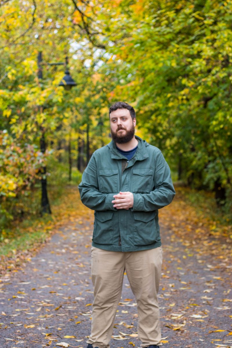 man standing in front of trail