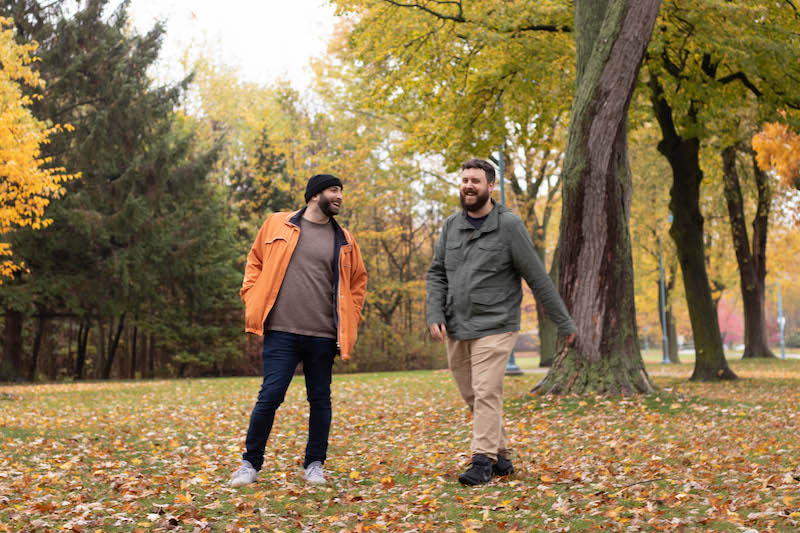 two men laughing in field