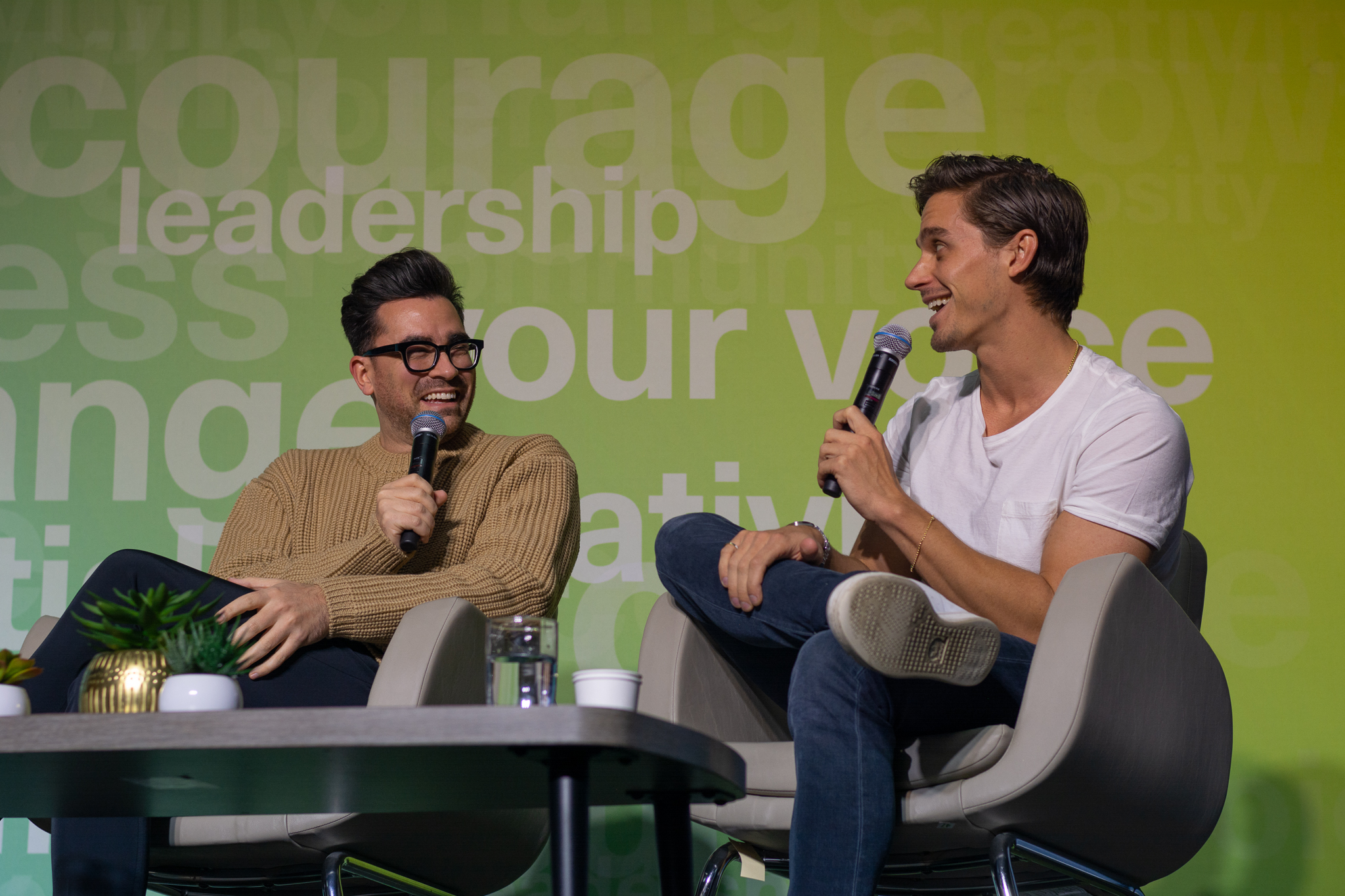 Antoni Porowski and Dan Levy laugh on stage