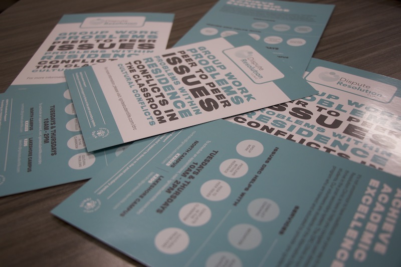 pile of dispute resolution clinic brochures