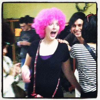 A woman in a pink clown wig