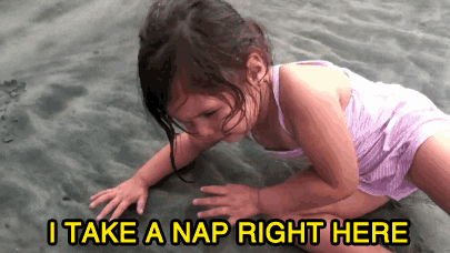 Little girl takes nap on beach