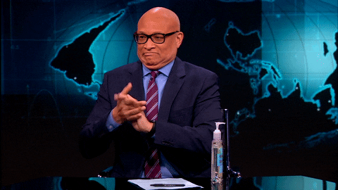 Talk show host applying hand sanitizer to both hands and in mouth