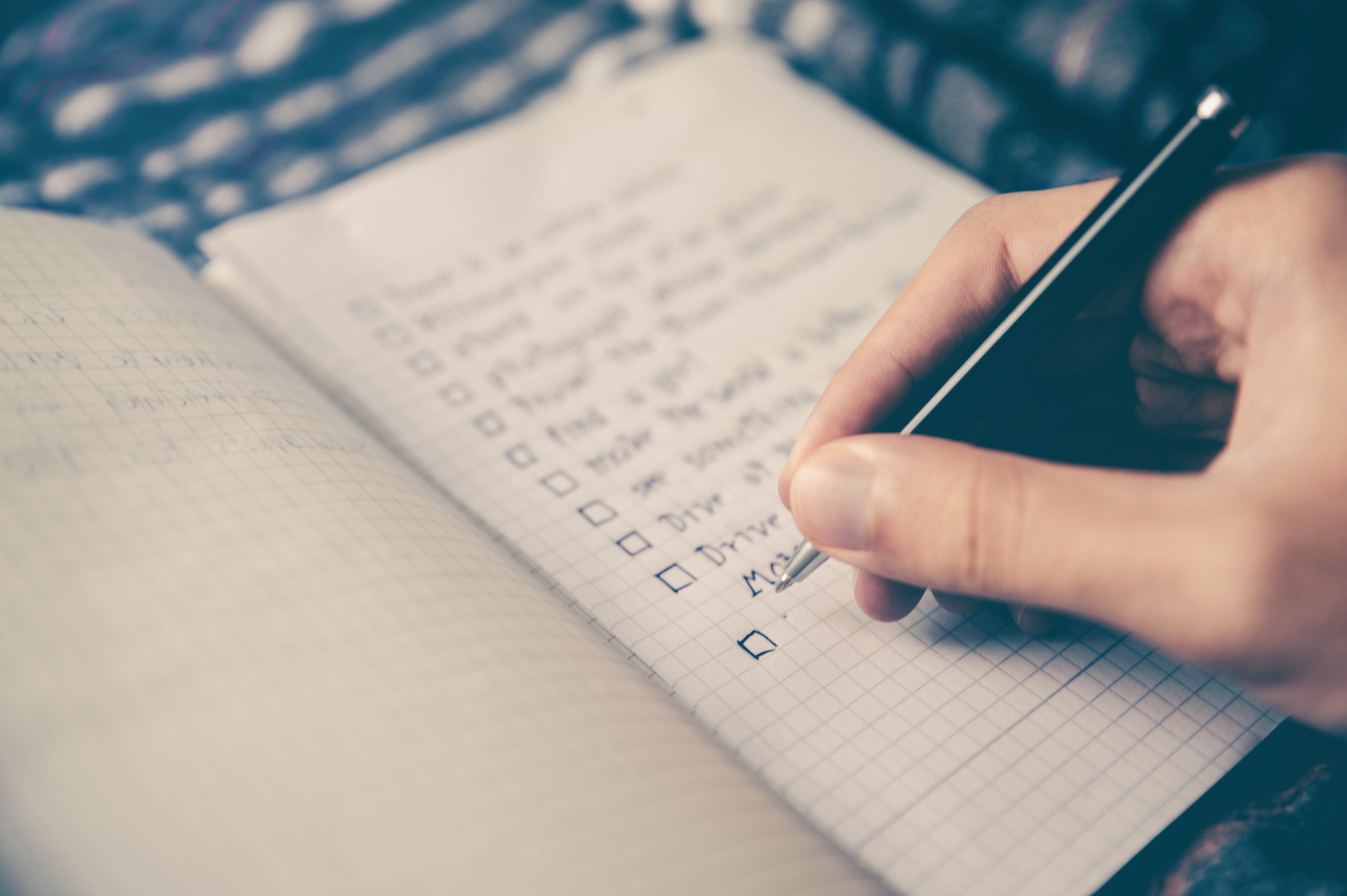 person checking off a to do list