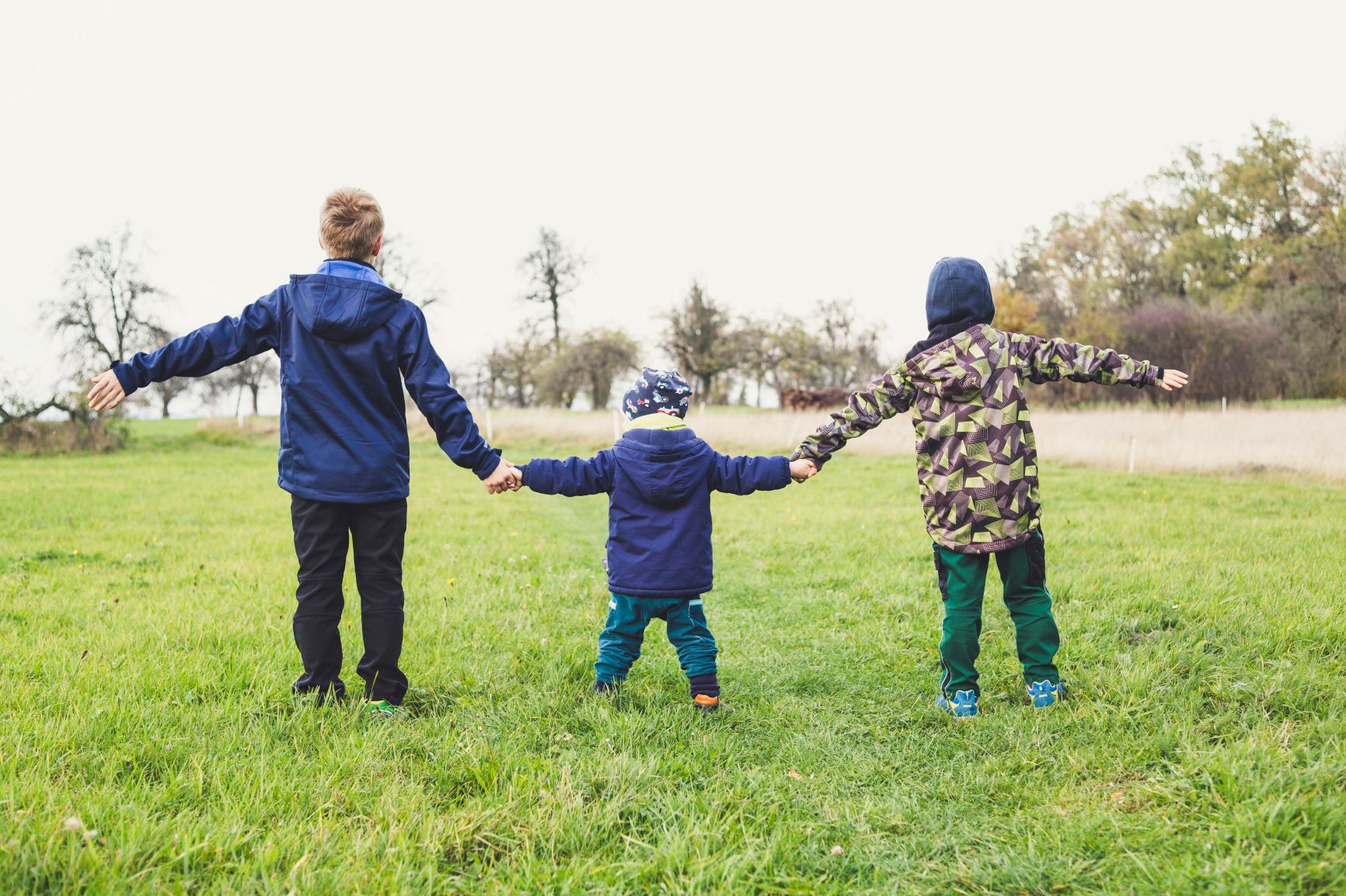 children standing in a line holding hands
